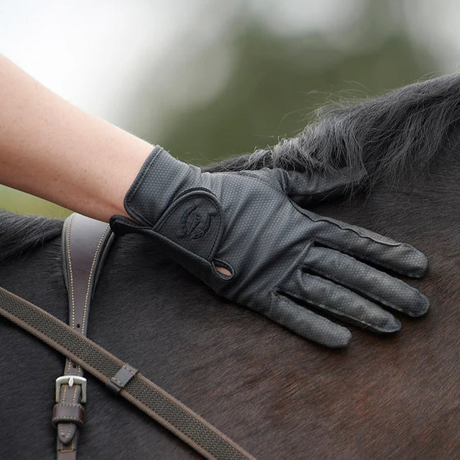 Kerrits Grip Lite Riding gloves on a rider's hand caressing the horse.