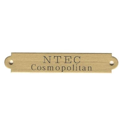 A brass name plate with the text 'NTEC Cosmopolitan' engraved on it as example of 2 line text.