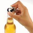 Bottle Opener Horse Shoe Keychain - Hand using a bottle opener keychain to open a beer bottle on a white background