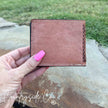Brown leather wallet held by a hand - Buckhorn Cowhide Men's Wallet