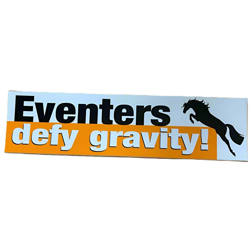 A bumper sticker with black and white text on an orange and white background that reads 'Eventers defy gravity'.