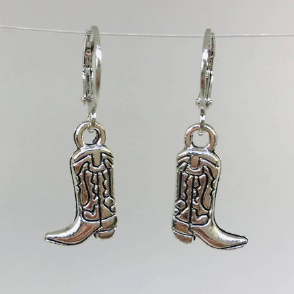 Silver cowboy boot earrings on a white background