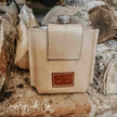 Desperado Tooled  Leather Flask with beige leather on wooden background with 'Countryside Co' branding.