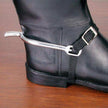 Black boot showing a spur with black nylon strap