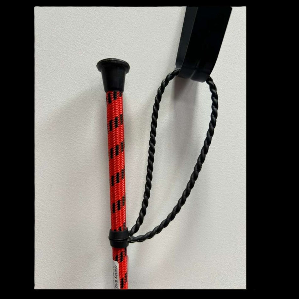 Gatsby English Riding Crop showing a close up of the handle in orange with black accents.
