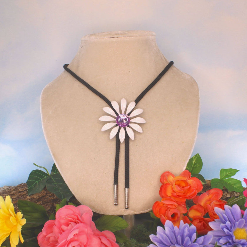 HHH Designs - 59mm White Enamel Daisy Bolo Tie With Purple Stone on display