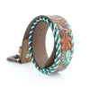 Leather dog collar with decorative patterns on a white background