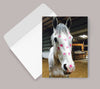 Horse Birthday Card: Horse Kiss Horse with pink kisses on a greeting card inside an open envelope.