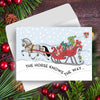 Horse Christmas Card - Santa Knows - with horse and sleigh illustration surrounded by festive decorations on a wooden surface.