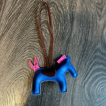 HorseHairz Equestrian Pony Purse/Bag Charm blue with pink mane and tail, brown saddle with brown string.