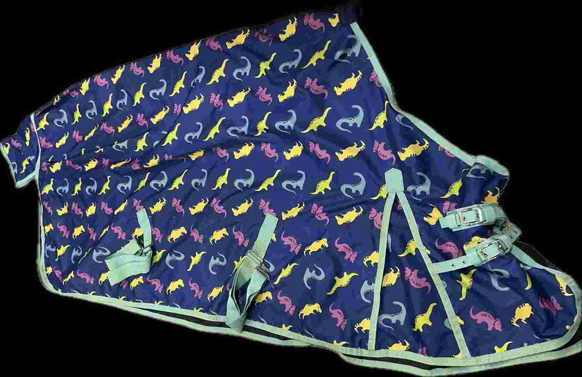 Navy blue horse blanket with colorful dinosaur pattern and green trim and closure belts and hooks