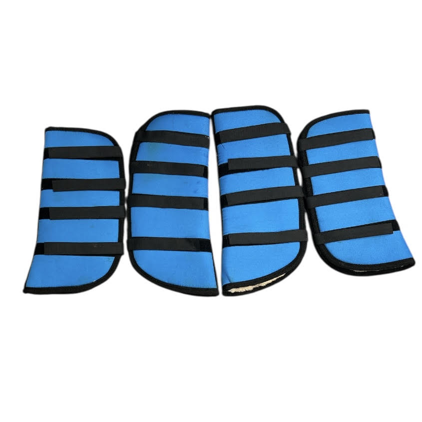 Four blue KHS-E Pony Shipping Boots with black velcro 