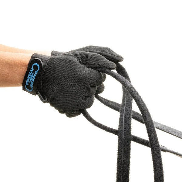 KHS EXCHANGE Correct Connect Rein and Glove Training System shows a close view of a rider holding the reins in hand.