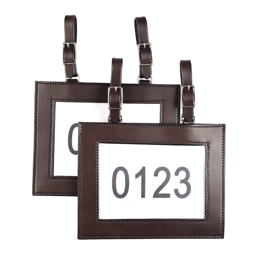 Ranch Leather Number Holders shown and sold as a pair in brown leather with two buckles on each for attaching to your saddle or tack.