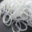 Loose pile of clear silicone rubber bands