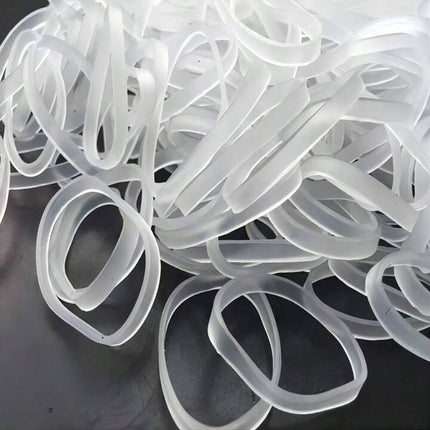 Loose pile of clear silicone rubber bands