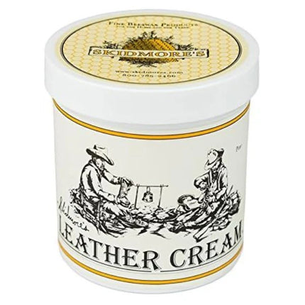 Container of Skidmore's Leather Cream with label showing an illustration of a person with a leather good, and text 'LEATHER CREAM'.