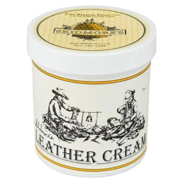 Container of Skidmore's Leather Cream with label showing an illustration of a person with a leather good, and text 'LEATHER CREAM'.