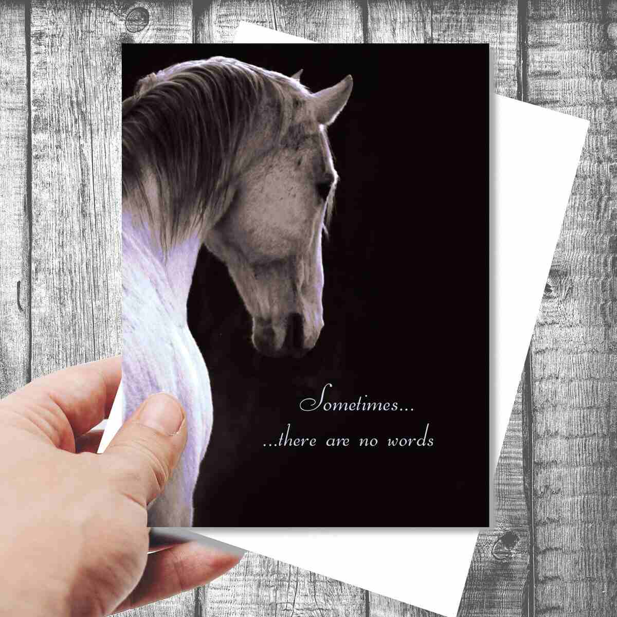 Sympathy Card - Sometimes ... with a horse image and text 'Sometimes... there are no words' held by a hand on a wooden surface.