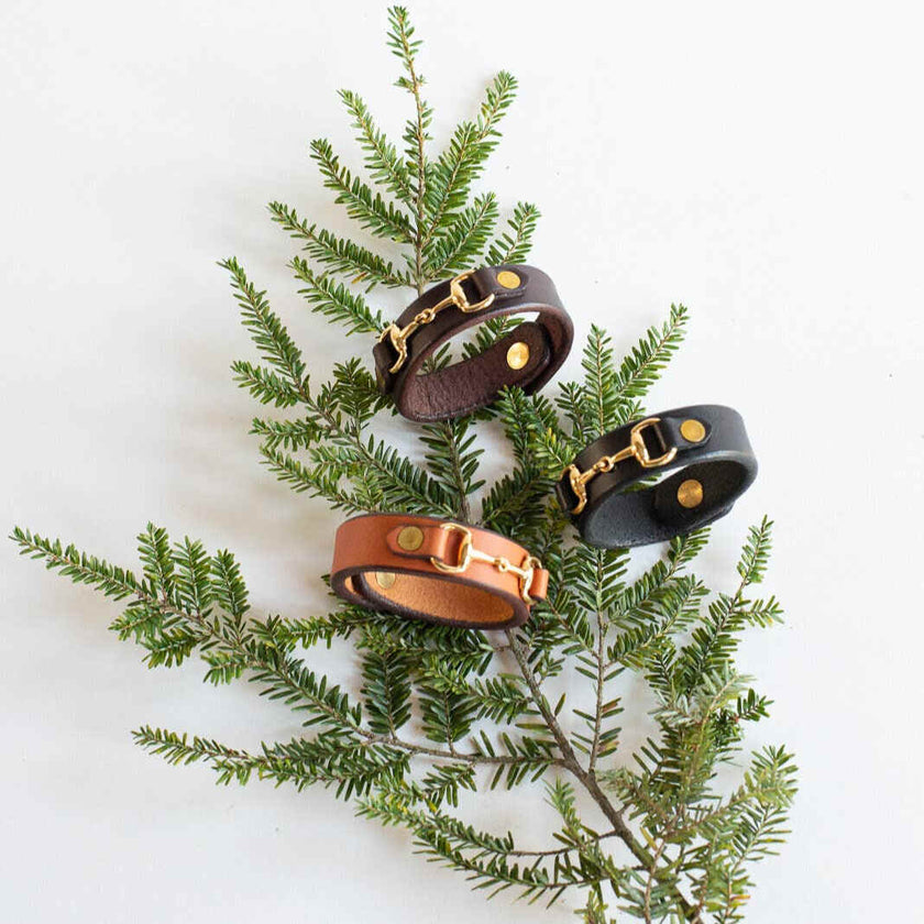 Three Leather Bit Bracelets in a Christmas decoration, three colors: light brown, dark brown and black.