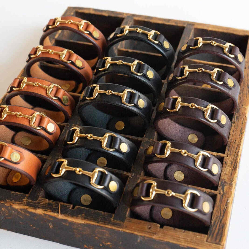 The Leather Bit Bracelet showing many in three colors - light brown, dark brown and black