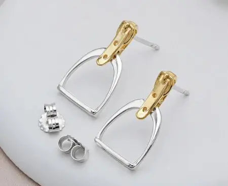 Two Tone Stirrup Earrings - Pair of gold and silver earrings on a light gray background