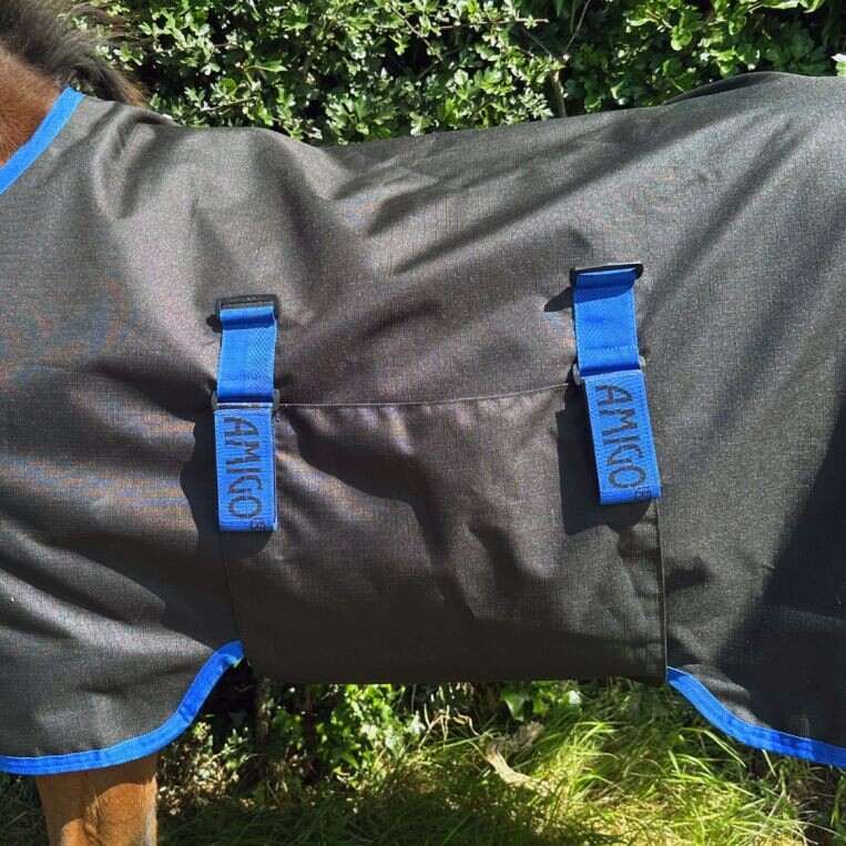 Horseware® Amigo Ripstop 900D Foal Turnout 200g in Black Classic Blue accents showing belly wrap closure.