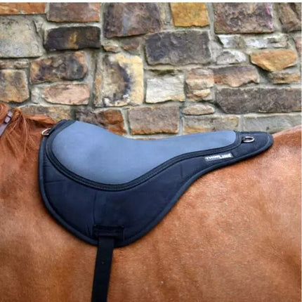 Black ThinLine Bareback Saddle Pad on a horse with a stone wall background