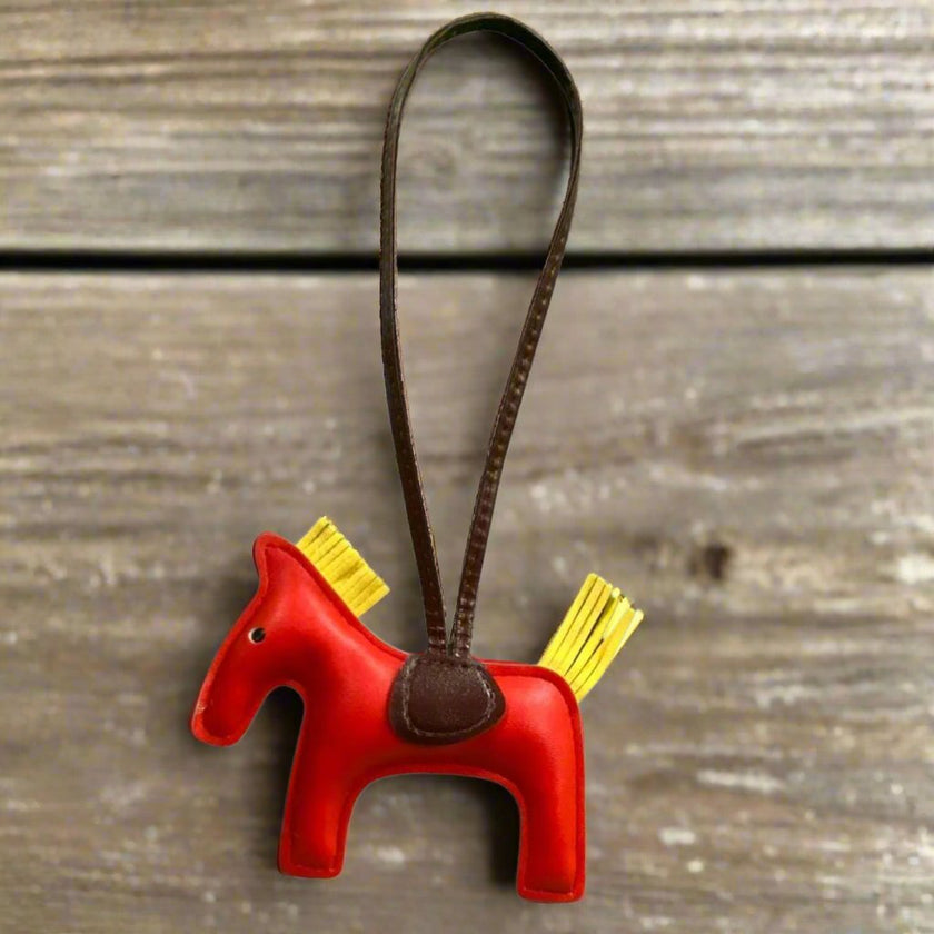 HorseHairz Equestrian Pony Purse/Bag Charm red with yellow mane and tail, brown saddle with brown string.