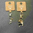 Two keychains with charms on brown cards labeled 'Handmade with love' -Handmade Animal Charm Key Chain.