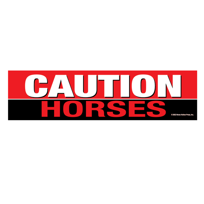 A red and black bumper sticker with white text that reads 'CAUTION HORSES!'